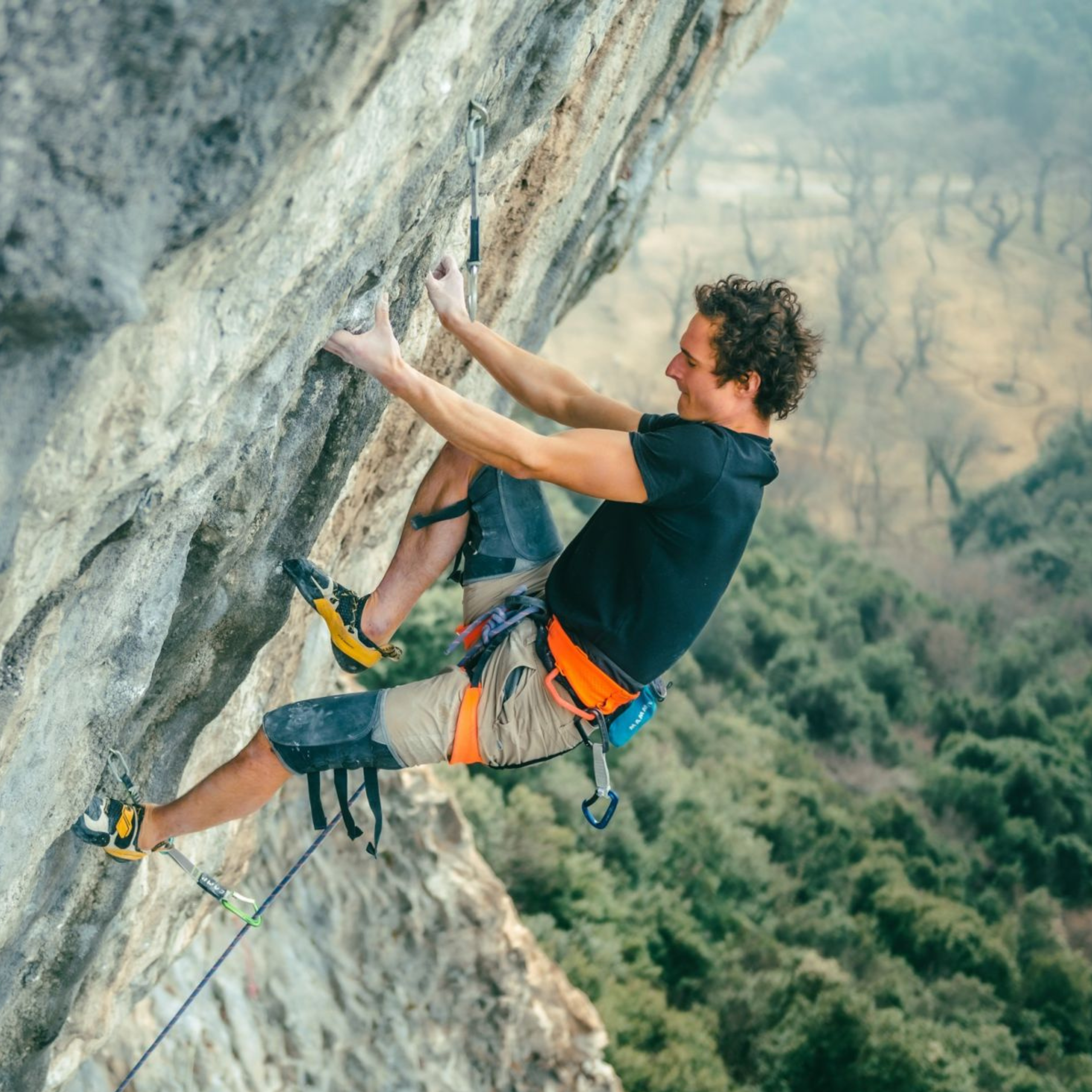 Man climbing mountain in LaSportiva shoes